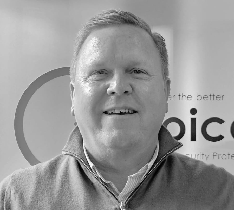 BarryCritchell Smiling man in a zip-up sweater poses in front of a partially visible company logo.